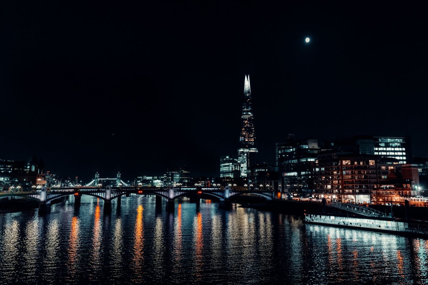 The Shard and Southwark lit up at night, reflected in the River Thames