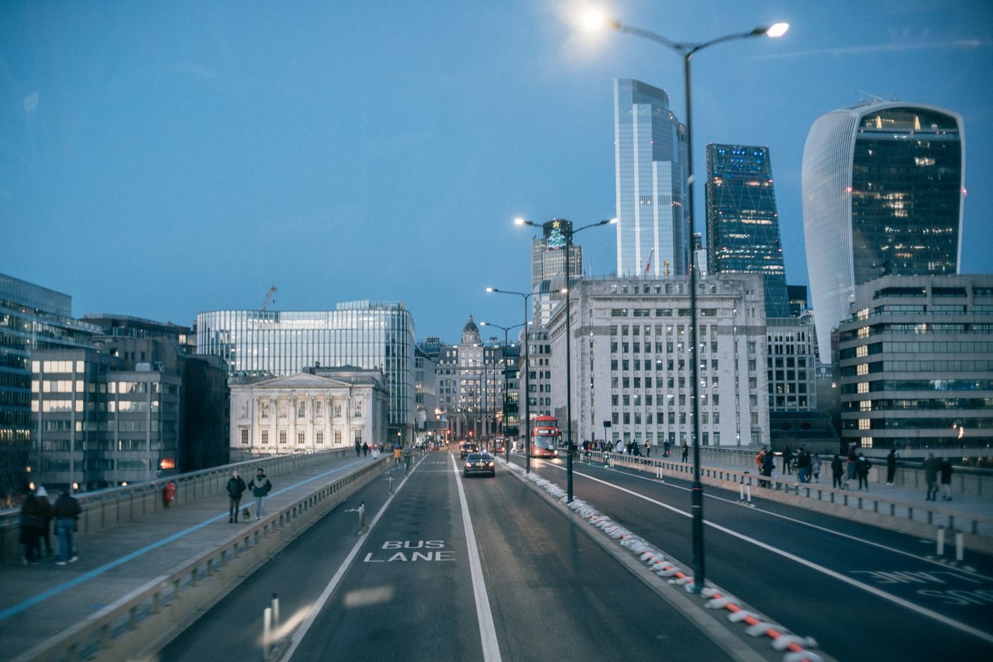 London Bridge and City towers at dusk with street lights coming on