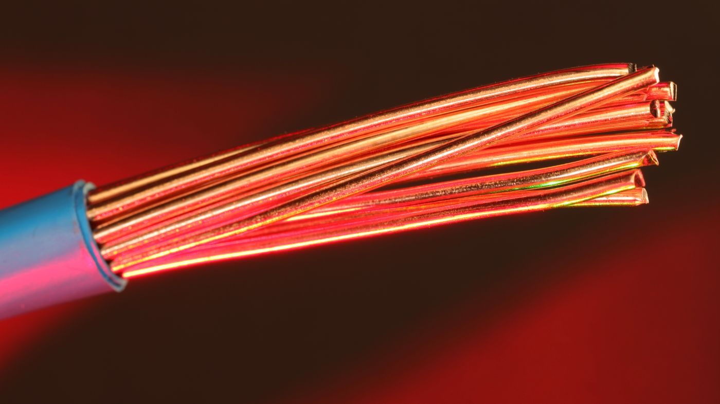 Stripped copper cable glowing red, suggesting overheating wiring